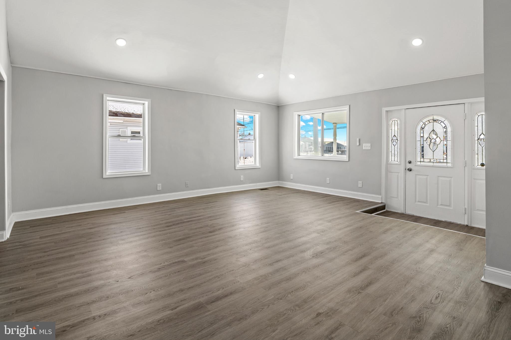 315 Riverside Drive Essex, MD 21221 - Photo 10 of 33 an empty room with wooden floor and windows