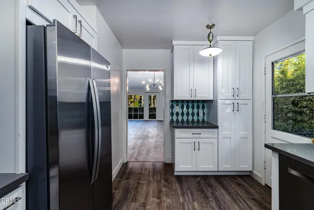 a kitchen with stainless steel appliances a refrigerator and cabinets