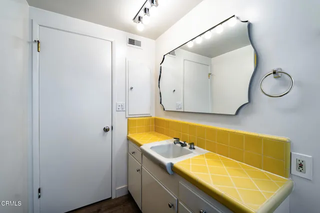 a bathroom with a tub sink and mirror