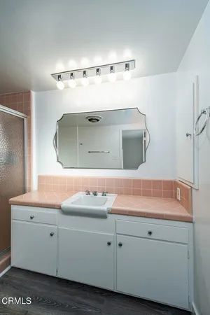 a bathroom with a sink and mirror