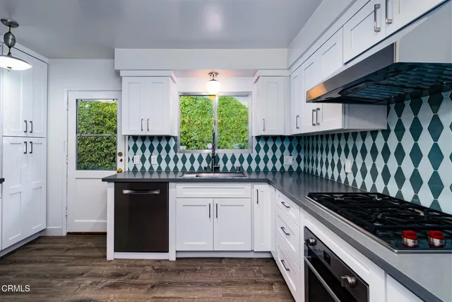 a kitchen with granite countertop a stove and a sink