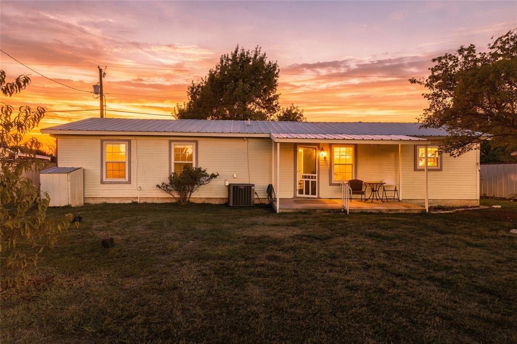 560 Green Acres Road Weatherford, TX 76088 - Photo 25 of 35 Single-story residence featuring light-colored siding, a metal roof, and a covered front porch