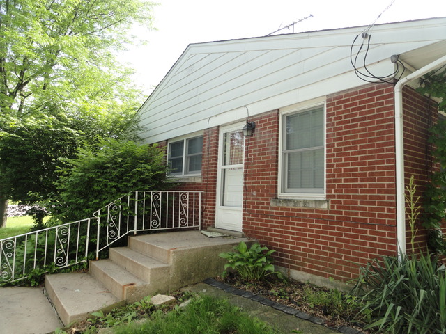 18324 Perth Avenue Homewood, IL 60430 - Photo 2 of 17 a view of a house with a small yard and wooden fence