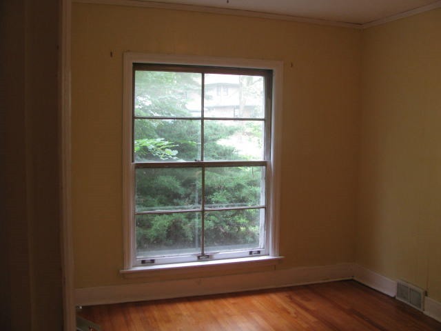 18324 Perth Avenue Homewood, IL 60430 - Photo 6 of 17 an empty room with wooden floor and windows