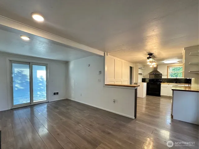a view of a kitchen with a sink and a stove top oven