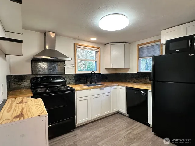 a kitchen with a sink stainless steel appliances and cabinets