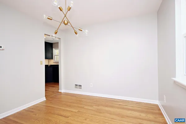 a view of a room with wooden floor and staircase