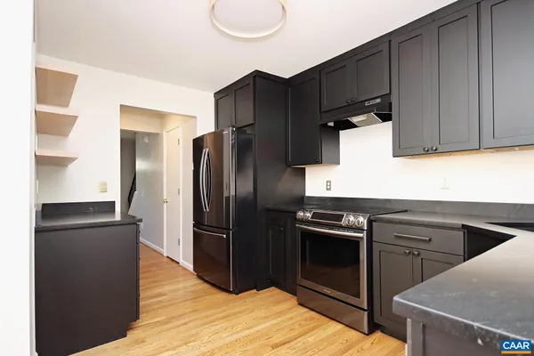 a kitchen with a refrigerator stove and sink