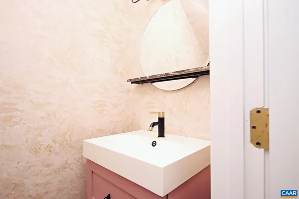 a bathroom with a sink a mirror and shower