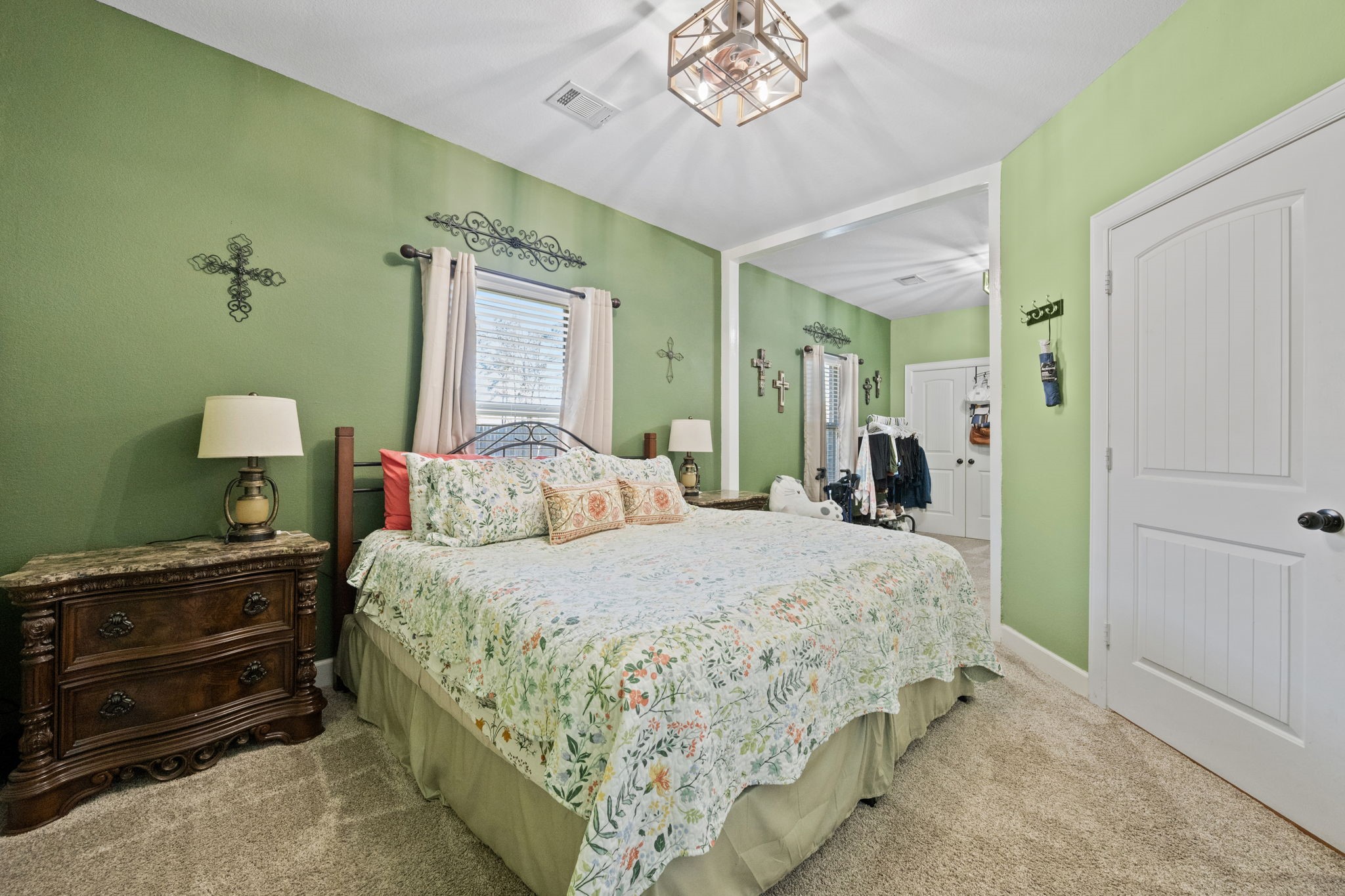 123 Noble View Court Magnolia, TX 77354 - Photo 18 of 29 a bedroom with a bed and a chandelier