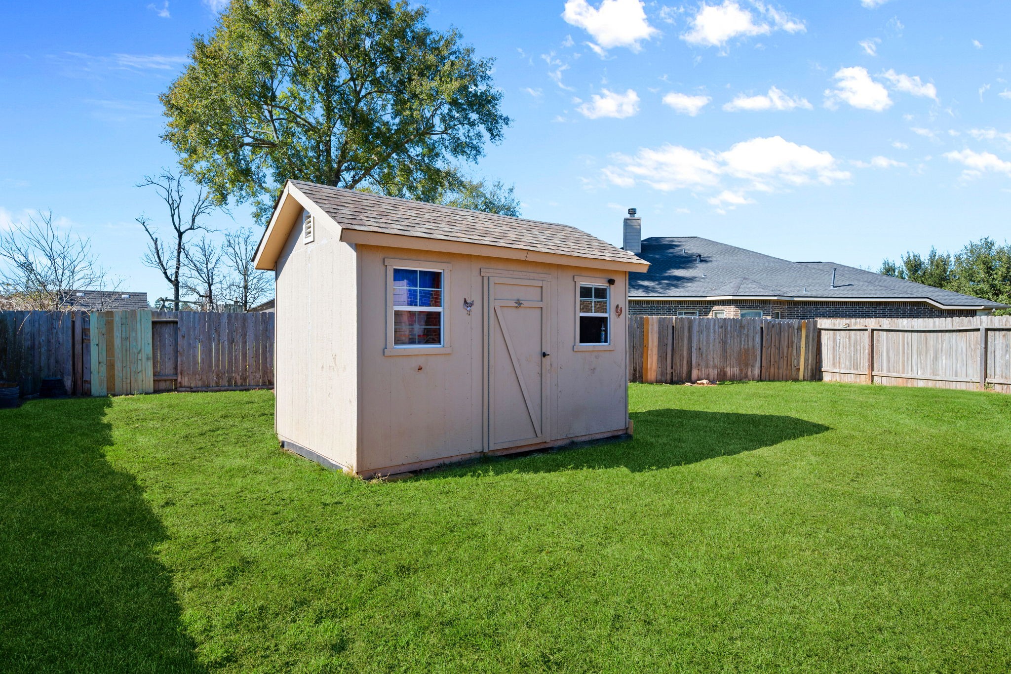 123 Noble View Court Magnolia, TX 77354 - Photo 27 of 29 a view of a house with backyard and a tree