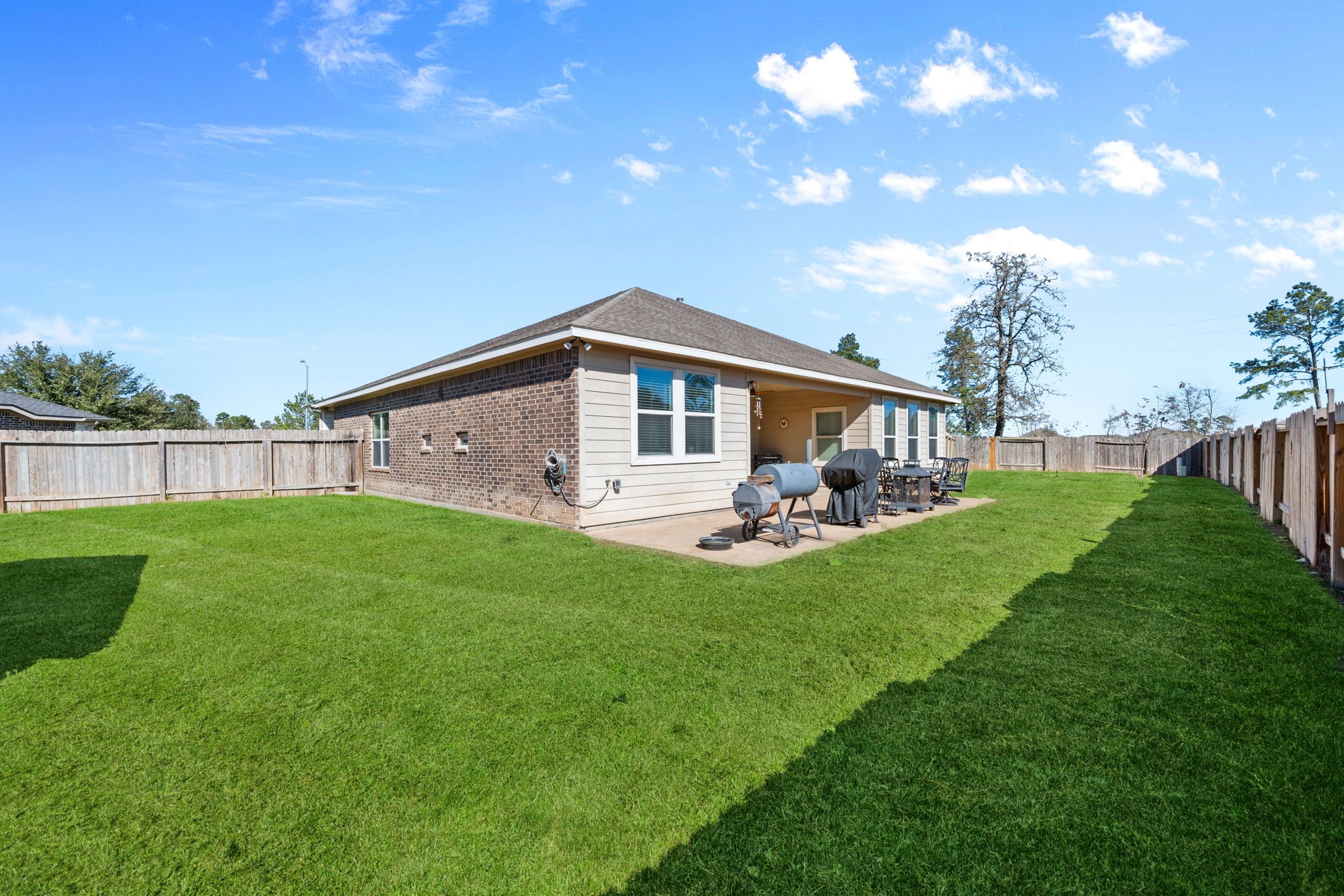 123 Noble View Court Magnolia, TX 77354 - Photo 28 of 29 a view of a house with a backyard