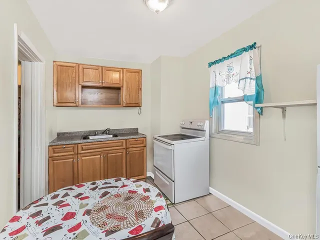a kitchen with a refrigerator sink stove and cabinets