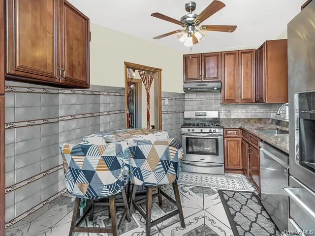 a kitchen with stainless steel appliances a stove a sink refrigerator and cabinets