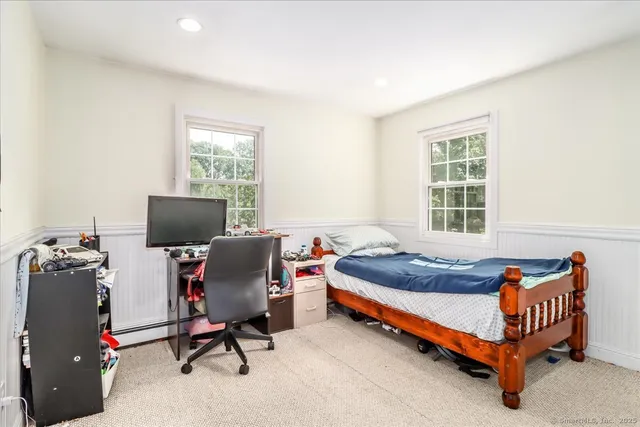 a bedroom with bed and a window