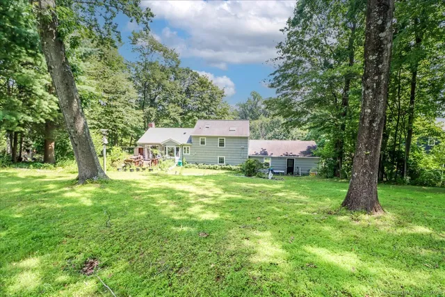 a view of a house with a backyard