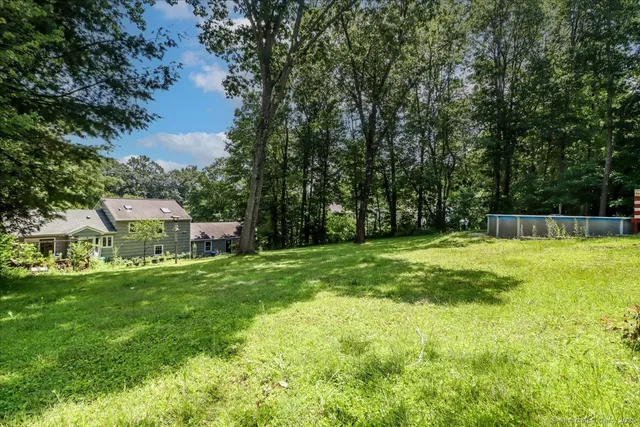 a view of a house with a backyard