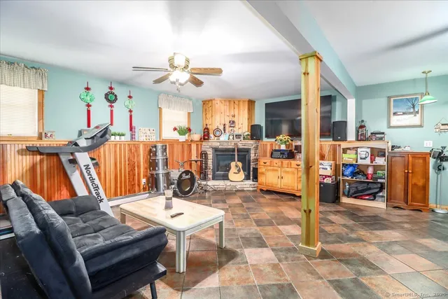 a living room with furniture a chandelier and a dining table