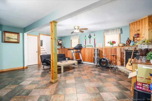 a view of a livingroom with furniture and a window