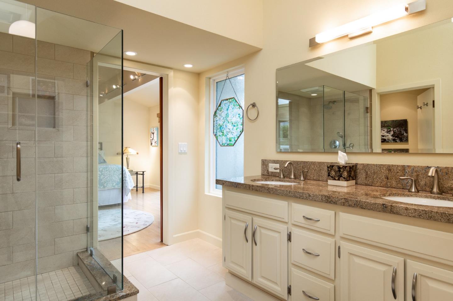 28056 Hawk Court Carmel, CA 93923 - Photo 15 of 22 a bathroom with a granite countertop sink mirror and shower