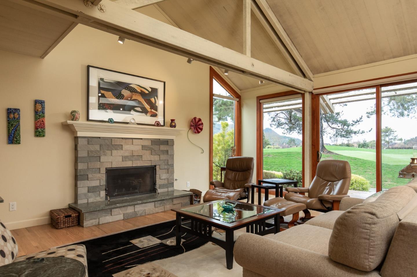 28056 Hawk Court Carmel, CA 93923 - Photo 2 of 22 a living room with furniture two large windows and a fireplace