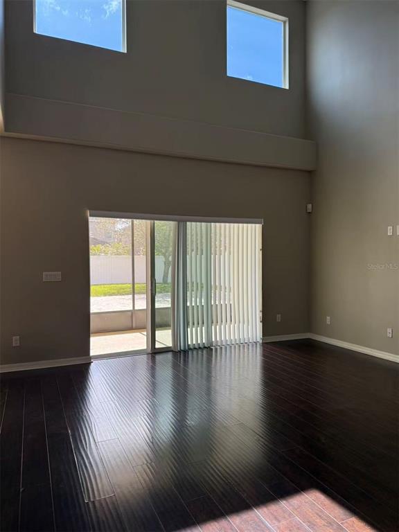 12016 Deer Path Way Orlando, FL 32832 - Photo 13 of 38 a view of an empty room with wooden floor and a window