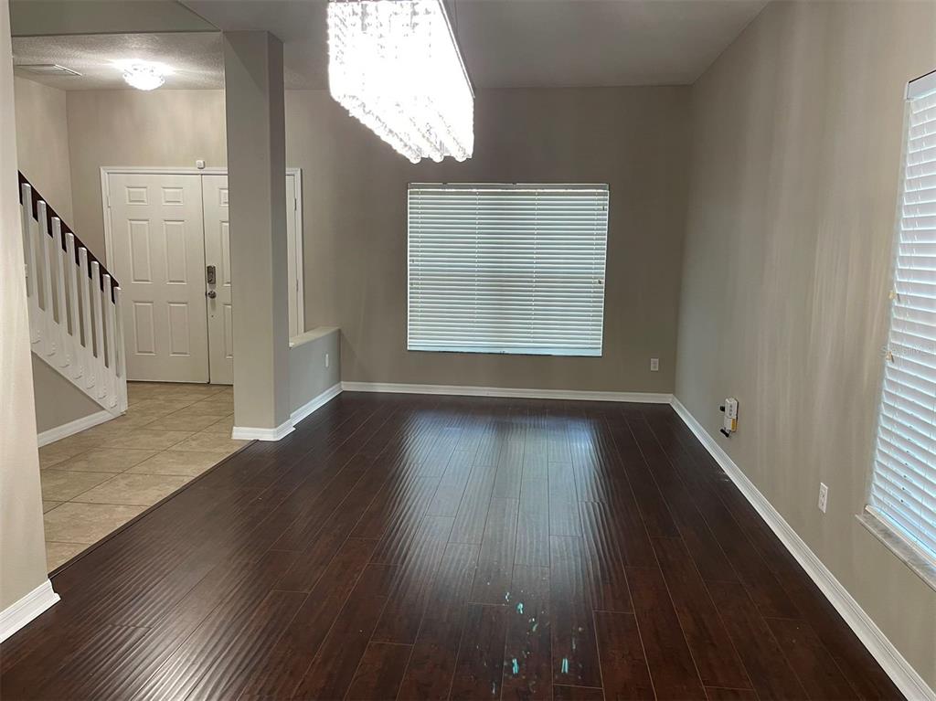 12016 Deer Path Way Orlando, FL 32832 - Photo 5 of 38 a view of an empty room with wooden floor and a window