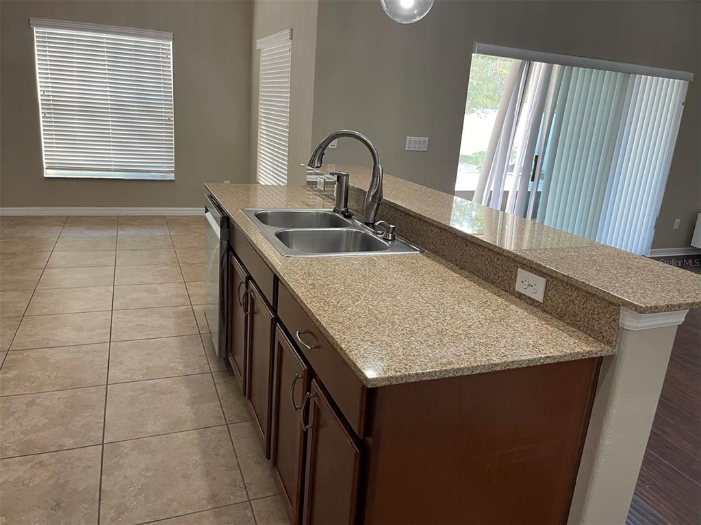 12016 Deer Path Way Orlando, FL 32832 - Photo 6 of 38 a kitchen with a sink a counter top space and cabinetry