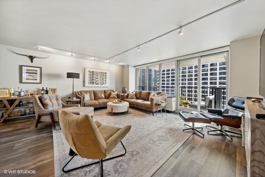 400 East Randolph Street, Unit 3429 Chicago, IL 60601 - Photo 15 of 44 a living room with furniture or couch and a wooden floor