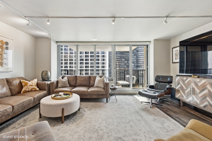400 East Randolph Street, Unit 3429 Chicago, IL 60601 - Photo 16 of 44 a living room with furniture and large windows