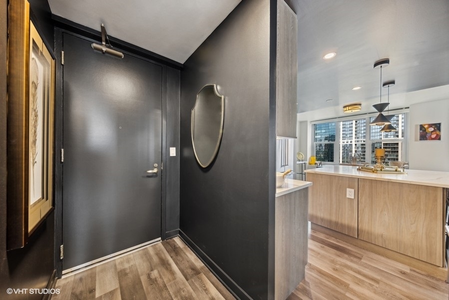 400 East Randolph Street, Unit 3429 Chicago, IL 60601 - Photo 4 of 44 a view of kitchen with cabinets and wooden floor
