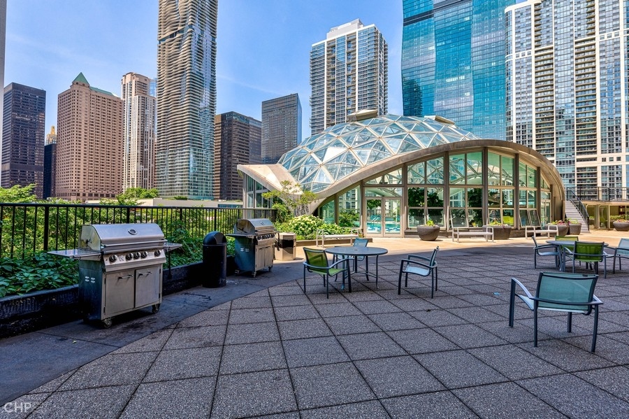 400 East Randolph Street, Unit 3429 Chicago, IL 60601 - Photo 43 of 44 a view of a patio with dining table and chairs