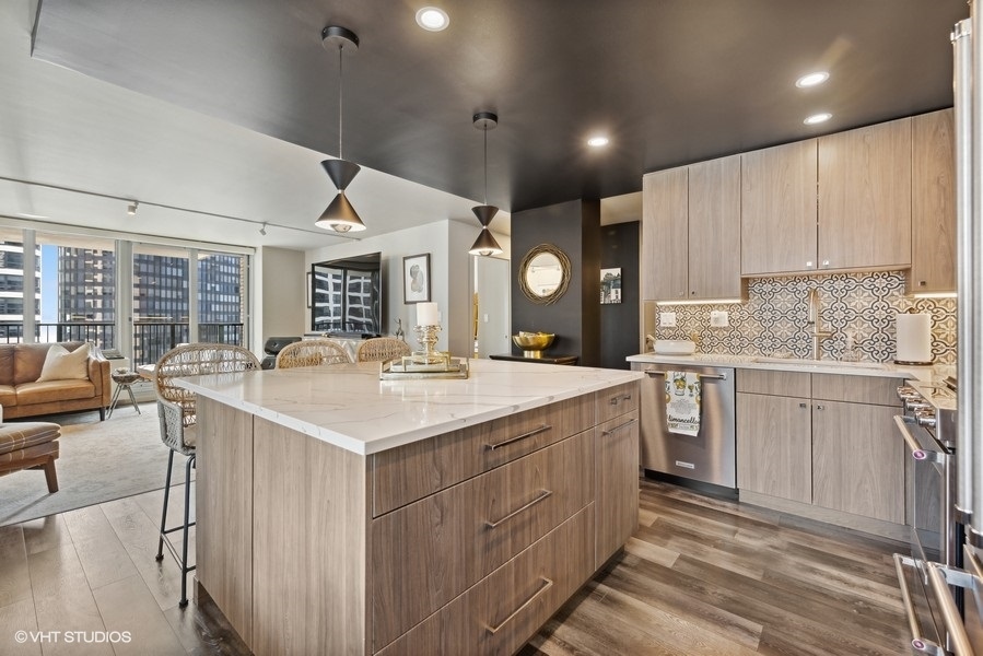 400 East Randolph Street, Unit 3429 Chicago, IL 60601 - Photo 8 of 44 a kitchen with a sink stove and cabinets
