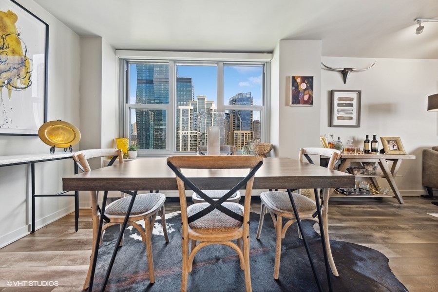 400 East Randolph Street, Unit 3429 Chicago, IL 60601 - Photo 10 of 44 a view of a dining room with furniture and window