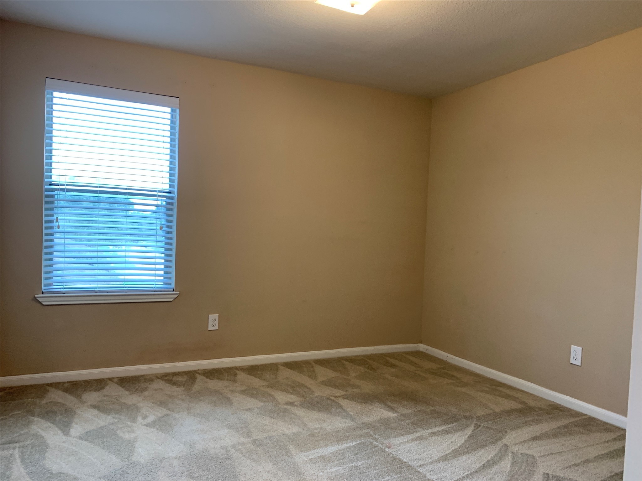 17038 Wilthorne Gardens Court Houston, TX 77084 - Photo 18 of 25 a view of an empty room with a window