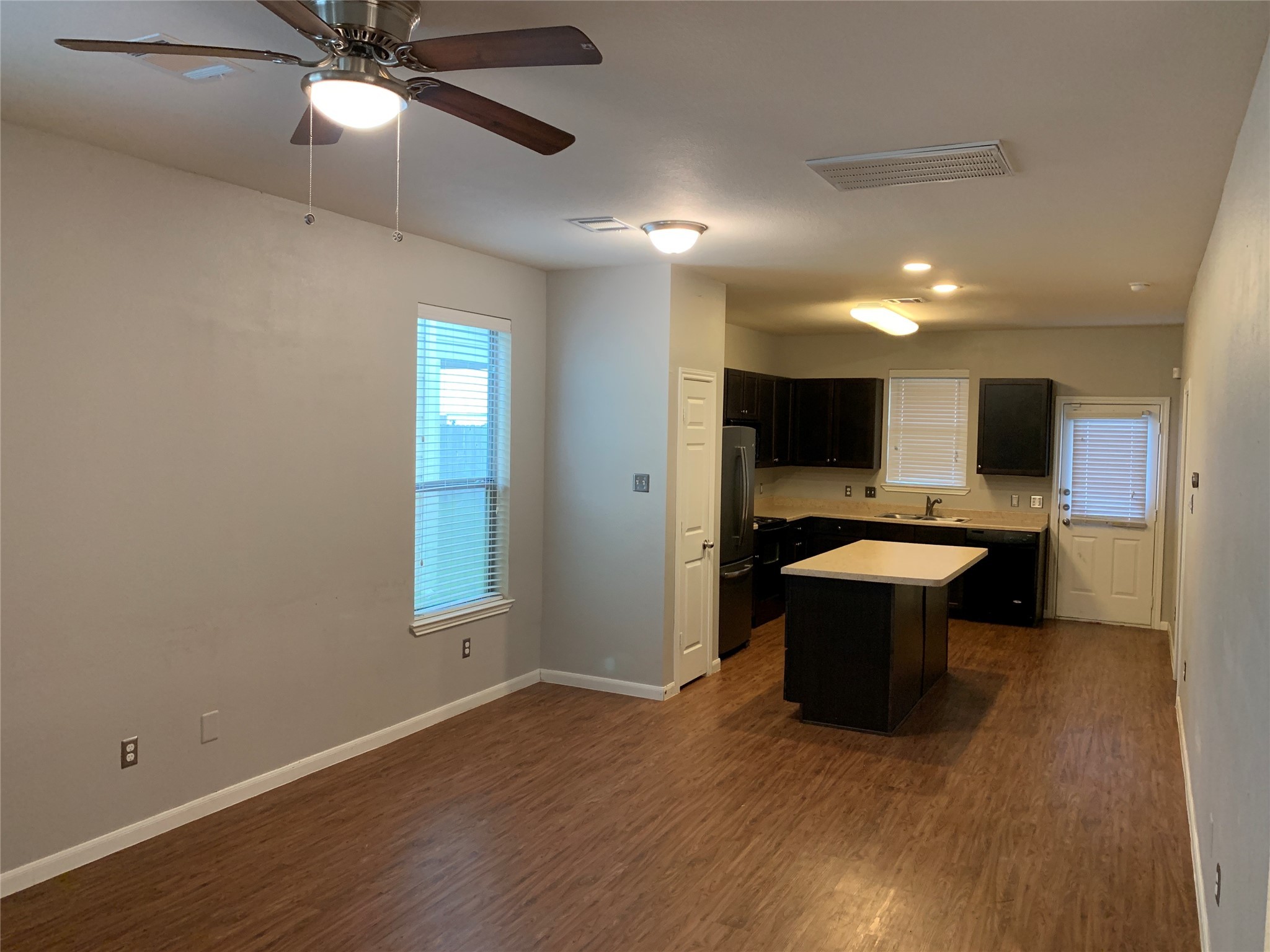 17038 Wilthorne Gardens Court Houston, TX 77084 - Photo 4 of 25 a view of kitchen with a sink and dishwasher with wooden floor