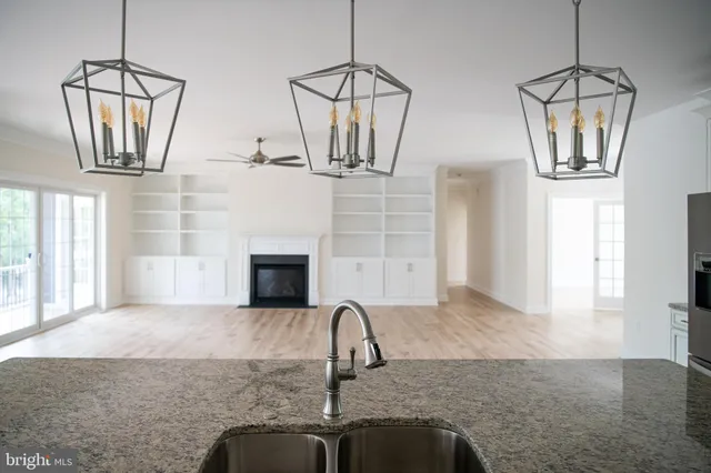 a living room with a fireplace furniture a ceiling fan and a rug