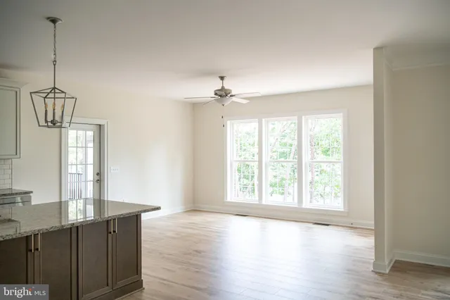 a view of empty room with a fireplace and cabinet