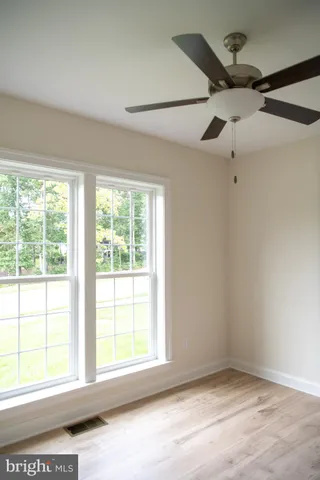 a spacious bathroom with a granite countertop sink a mirror and a bathtub