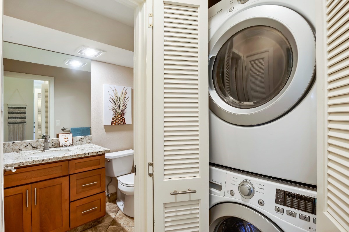 1565 Pe'e Road, Unit 415 Koloa, HI 96756 - Photo 8 of 18 a view of a bathroom with washing machine and washing machine