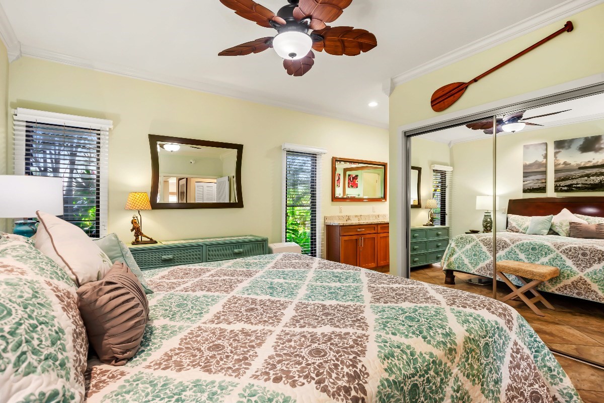 1565 Pe'e Road, Unit 415 Koloa, HI 96756 - Photo 9 of 18 a bedroom with a bed and wooden floor