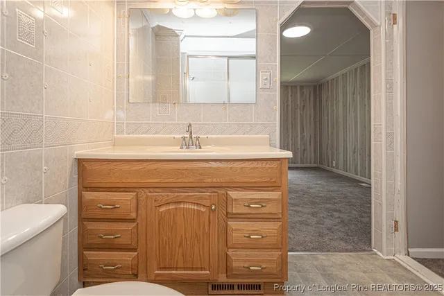 a bathroom with a sink a vanity and a mirror