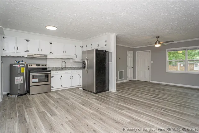 a kitchen with stainless steel appliances a refrigerator sink and cabinets