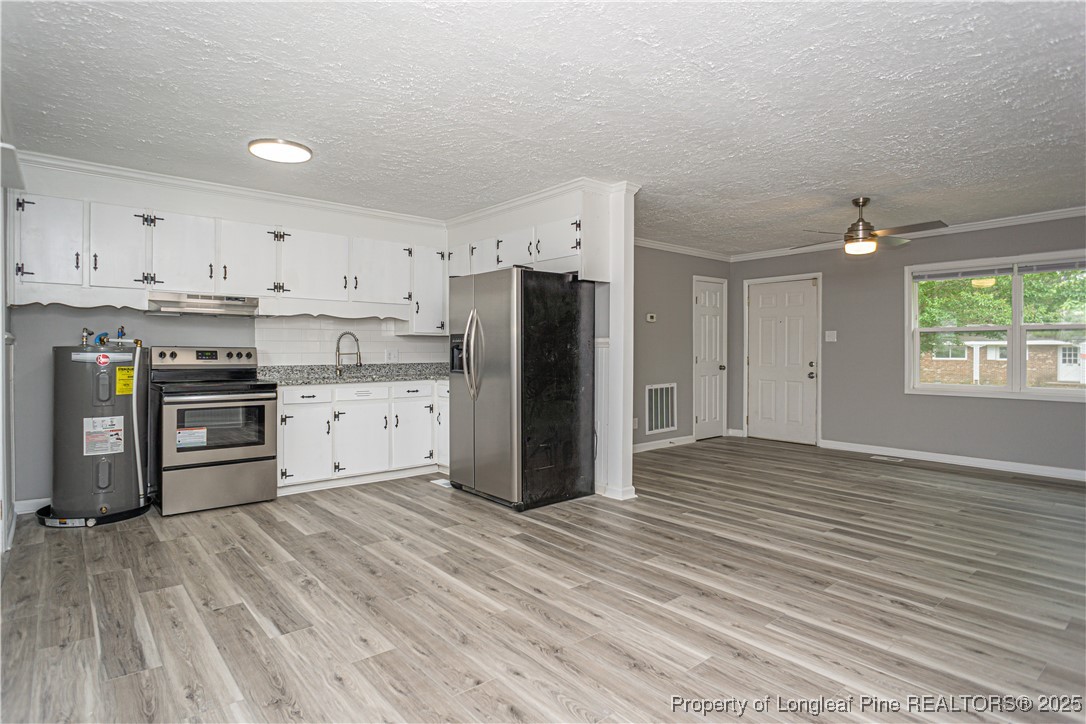 2701 Daly Avenue Spring Lake, NC 28390 - Photo 18 of 34 a kitchen with stainless steel appliances a refrigerator sink and cabinets