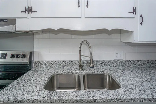 a kitchen with a sink and cabinets