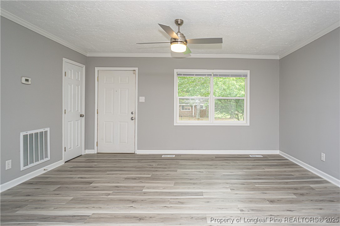 2701 Daly Avenue Spring Lake, NC 28390 - Photo 2 of 34 a view of an empty room with wooden floor and a window