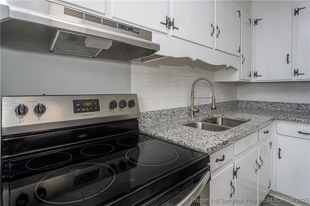 2701 Daly Avenue Spring Lake, NC 28390 - Photo 21 of 34 a kitchen with stainless steel appliances granite countertop a sink stove and cabinets