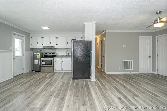 a kitchen with stainless steel appliances granite countertop a refrigerator oven a sink dishwasher and a stove with wooden floor