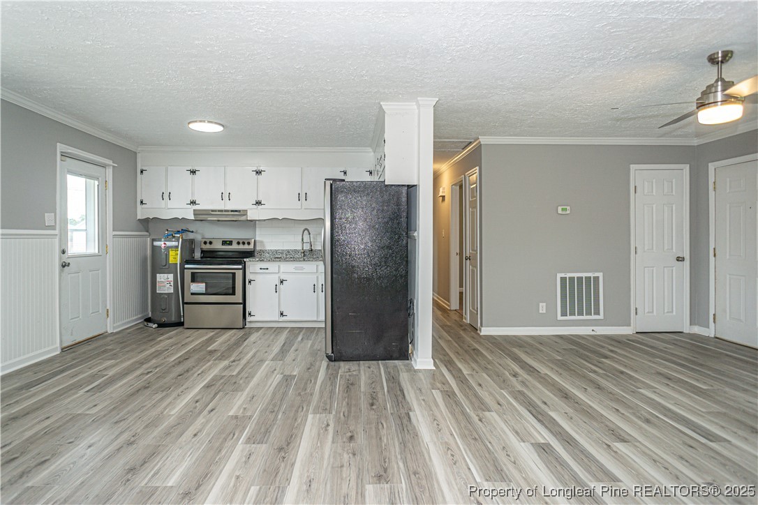 2701 Daly Avenue Spring Lake, NC 28390 - Photo 24 of 34 a kitchen with stainless steel appliances granite countertop a refrigerator oven a sink dishwasher and a stove with wooden floor