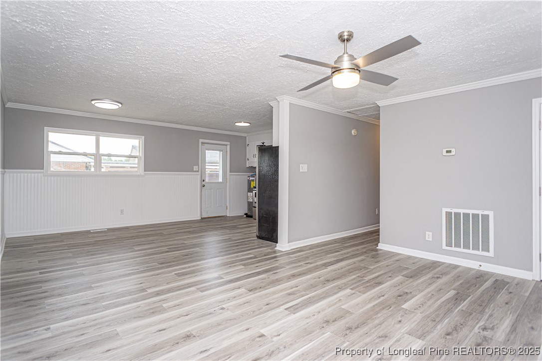 2701 Daly Avenue Spring Lake, NC 28390 - Photo 26 of 34 a view of an empty room with wooden floor and a ceiling fan